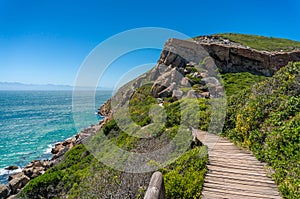 Wooden trek, path on a cliff with ocean on the background