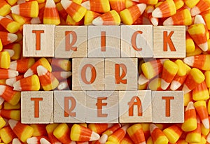 Wooden Trick or Treat sign with a Background of Classic Candy Corn