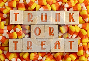 Wooden Trunk or Treat sign with a Background of Classic Candy Corn