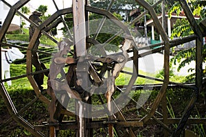 Wooden turbine baler or wood water wheels in creek canal for treatment water on pool pond at outdoor garden park at Wat Huay Pla