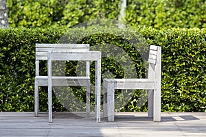 Wooden two chairs and white table in empty cafe of a tropical garden on the beach, Thailand. Close up