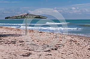 Wooden umbrella on empty beach