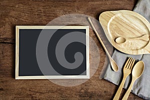 wooden utensil in kitchen on old wooden background with blackboard