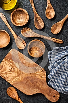 Wooden utensil set on black stone surface