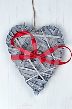 Wooden Valentines Day heart with red ribbon bow