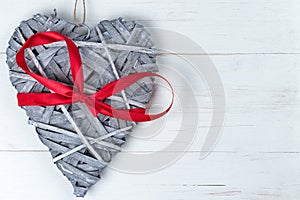 Wooden Valentines Day heart with red ribbon bow