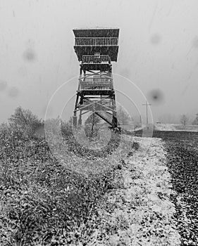 Wooden view tower on Kozia Gora hill above Prudnik town in Poland during heavy snowffaling