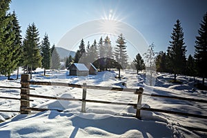 Wooden village house in snowy winter