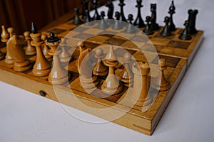 Wooden vintage chess pieces on a chessboard close-up. Playing chess. Strategy, planning, business game concept