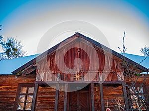 Wooden vintage country house in mountains forest covered snow on nature landscape. Active rest. Snowy winter holidays