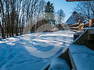 Wooden vintage country house in mountains forest covered snow on nature landscape. Active rest. Snowy winter holidays