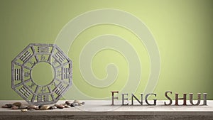 Wooden vintage table shelf with ba gua and 3d letters making the word feng shui with yellow green background with copy space, zen