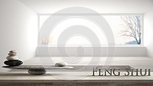 Wooden vintage table shelf with stone balance and 3d letters making the word feng shui over empty room with big panoramic window,