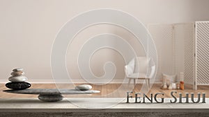 Wooden vintage table shelf with stone balance and 3d letters making the word feng shui over white background with armchair, screen