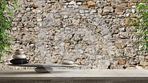 Wooden vintage table or shelf with stone balance, over blurred old brick damaged stone wall, feng shui, zen concept architecture i