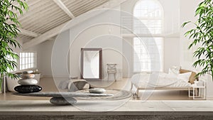 Wooden vintage table or shelf with stone balance, over blurred scandinavian loft with bedroom and bathroom with bathtub, feng shui