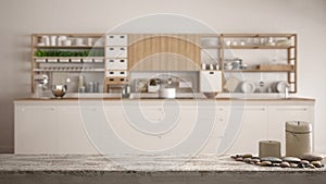 Wooden vintage table top or shelf with candles and pebbles, zen mood, over blurred empty minimalist white wooden kitchen closeup,