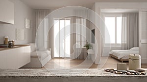 Wooden vintage table top or shelf with candles and pebbles, zen mood, over blurred small apartment with kitchen, living room and b