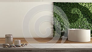 Wooden vintage table top or shelf with candles and pebbles, zen mood, over minimal bathroom with bathtub and vertical garden,