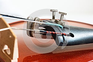 Wooden violin close up detail shot of bridge and cord tuners