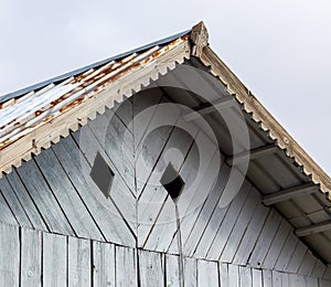 Wooden visor on the roof of the house