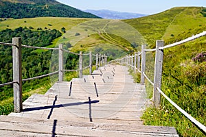 Wooden walking path in puy de dome french mountains in summer day