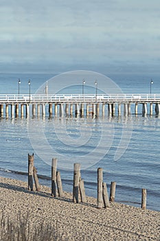 Wooden walking sea Gdynia Orlowo Pier with old foundation piles on coast in Poland