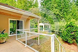 Wooden walkout deck with glass railing photo