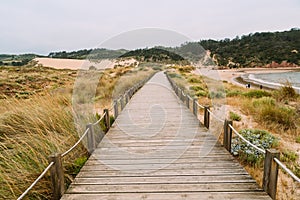 Wooden walkway along the bay and the beach of Sao Martinho do Porto photo