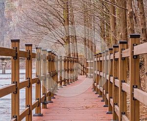 Wooden walkway alongside frozen river