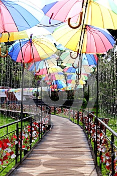 Wooden walkway with colorful umbrellas
