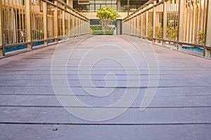 Wooden walkway cross over swimming pool at outside the resort.