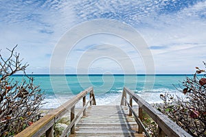 Wooden Walkway Leading Down to a Picturesque Turquoise Ocean