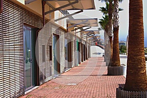 Wooden walkway of a modern touristy port in italy photo