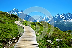 Wooden walkway in the mountain landscape. Nature Reserve Aiguilles Rouges, French Alps.