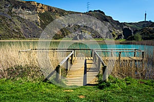 Wooden footbridge next to a lake, la arboleda, basque country photo