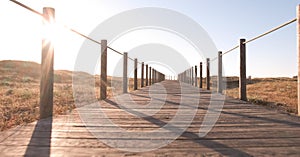 Wooden walkway over sand dunes on beach in Portugal on a hazy summer afternoon