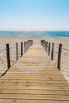Wooden walkway over the sand dunes to the beach. Beach pathway i