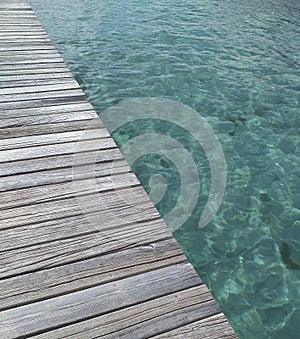 Wooden walkway over transparent and turquoise waters. Caribbean landscape