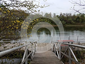 Wooden walkway or ramp floating platform and picnic table and lake