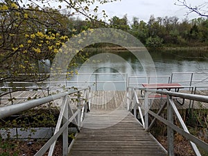 Wooden walkway or ramp floating platform and picnic table and lake
