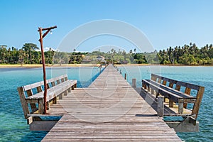 Wooden walkway with seats the lead to the sea and beach in summer in Koh Mak Island at Trat, Thailand