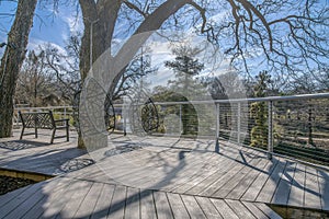 Wooden walkway with swings and bench at the San Antonio River Walk in Texas