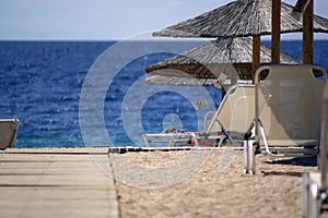 Wooden Walkway To Sand Beach with Sunshades photo