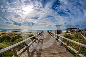 Wooden walkways lead to water in famous beach of Tres Irmaos in Alvor, PortimÃ£o, Algarve, Portugal, Europe. Praia dos Tres Irmaos