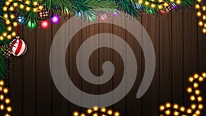 Wooden wall with Christmas tree branch and Christmas decor. Background for your arts with copy space