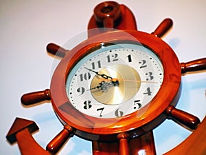 Wooden wall clock with ship anchor and rudder