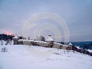 Wooden wall of the fortress on a hill in winter