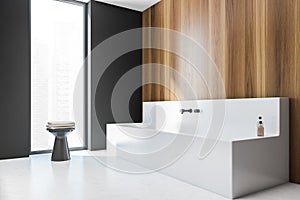 Wooden wall modern stylish hotel bathroom interior, with square ceramic bathtub. Panoramic window