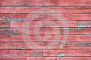 Wooden wall with red horizontal boards laid in the form of brick